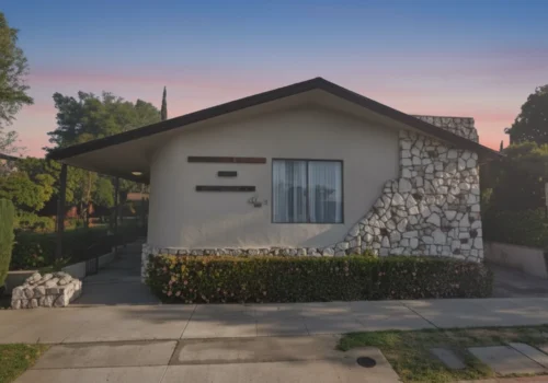 front view of Arbor Vista assisted living home with stone façade and landscaped garden