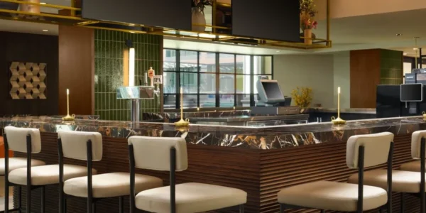 Modern bar and lounge at Courtyard by Marriott Pasadena Old Town with marble counter and ambient lighting.