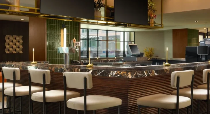 Modern bar and lounge at Courtyard by Marriott Pasadena Old Town with marble counter and ambient lighting.