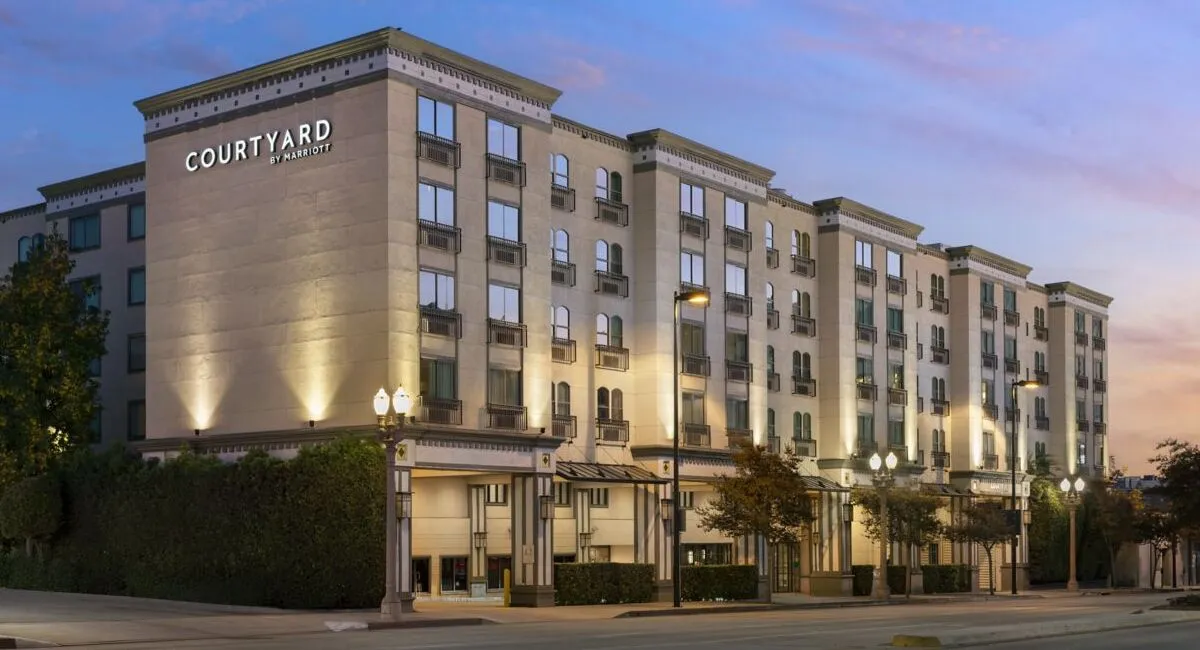 Courtyard by Marriott Pasadena Old Town hotel exterior at dusk with warm lights and elegant facade.