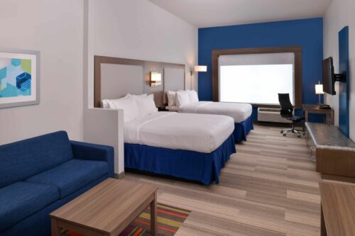 Holiday Inn Express hotel room with two double beds, blue accents and work desk