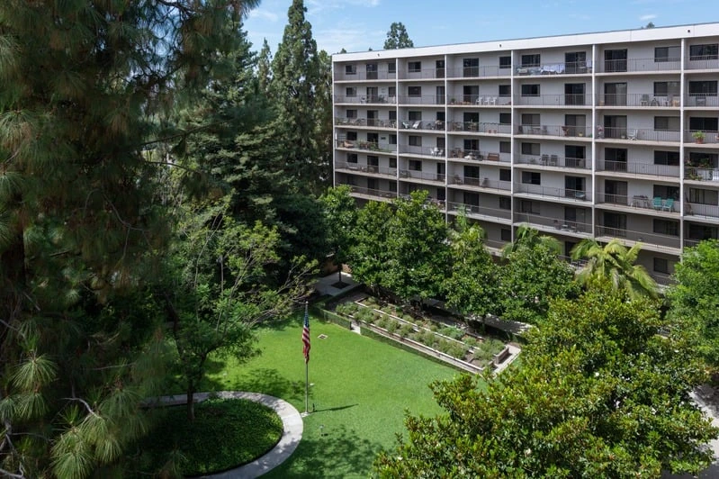 Exterior view of Pasadena Highlands senior living community in Pasadena, offering on-site medical support and wellness programs