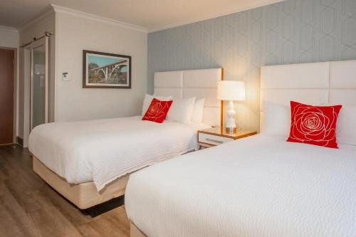 Guest room at Pasadena Rose and Crown with two double beds and modern decor