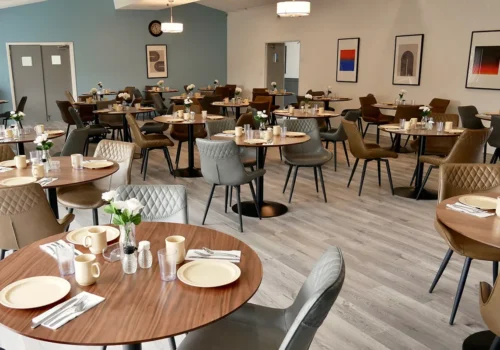 Spacious dining area with elegant tables and soft lighting at Pasadena Villa Senior Living in Pasadena.