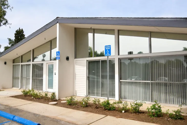 Front exterior of Pasadena Villa Senior Living showing accessible entry and modern architectural design.