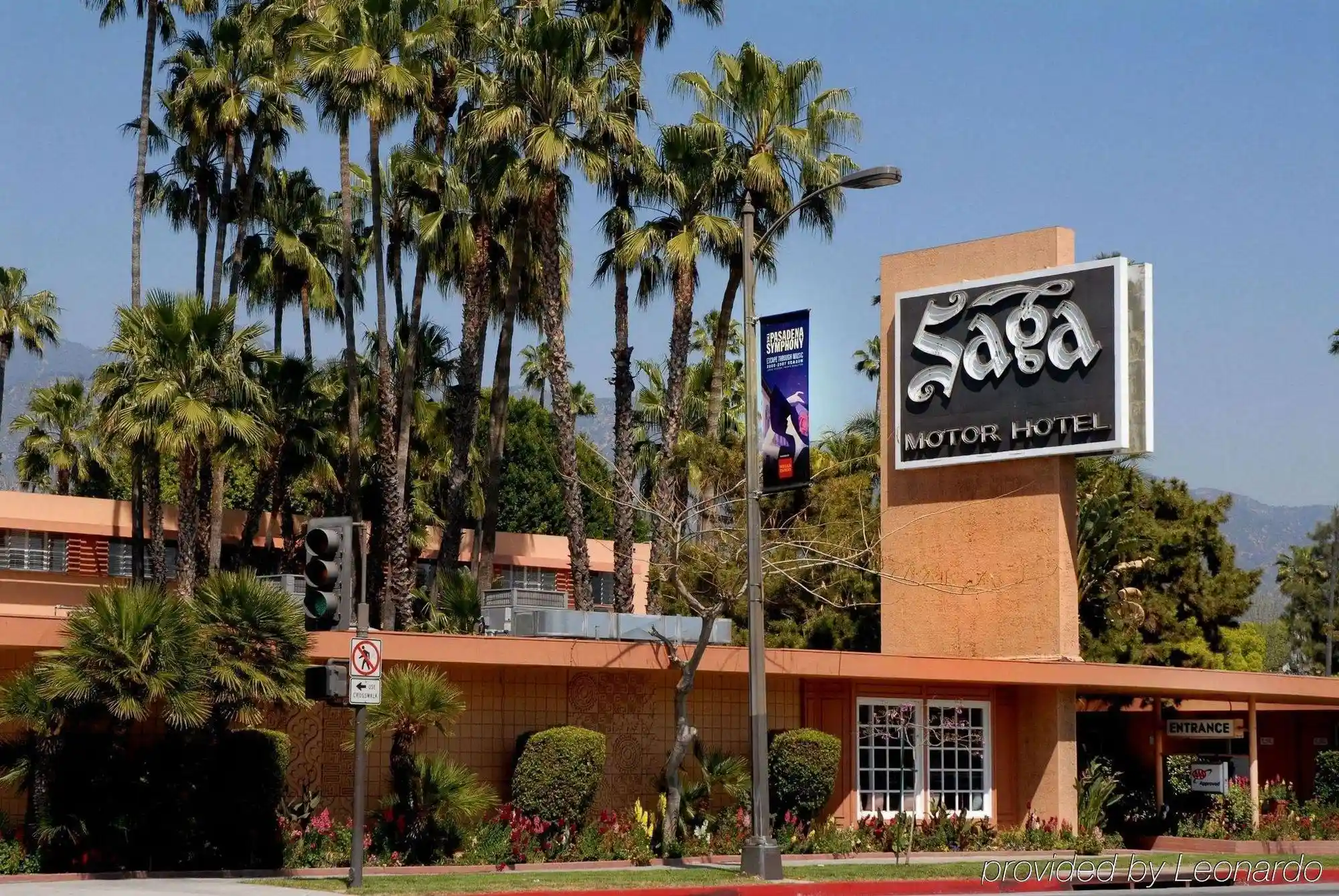 front view of Saga Motor Hotel with palm trees in Pasadena