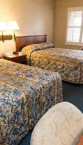guest room at Saga Motor Hotel with two double beds and desk