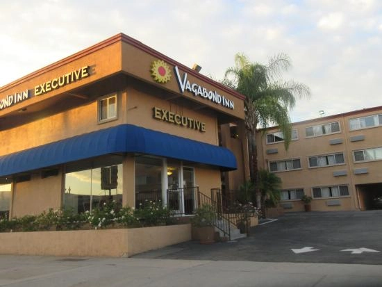 Exterior of Vagabond Inn Executive with entrance and parking area