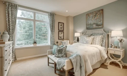 Calm resident suite with soft blue tones and large window view at The Kensington Sierra Madre