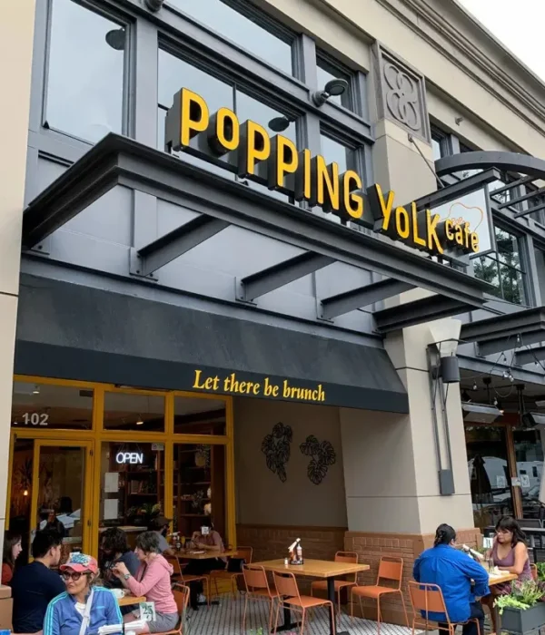 Popping Yolk Cafe storefront in Old Pasadena with yellow signage and outdoor patio seating.