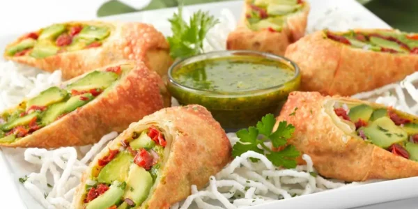 Avocado Eggrolls appetizer with dipping sauce at The Cheesecake Factory