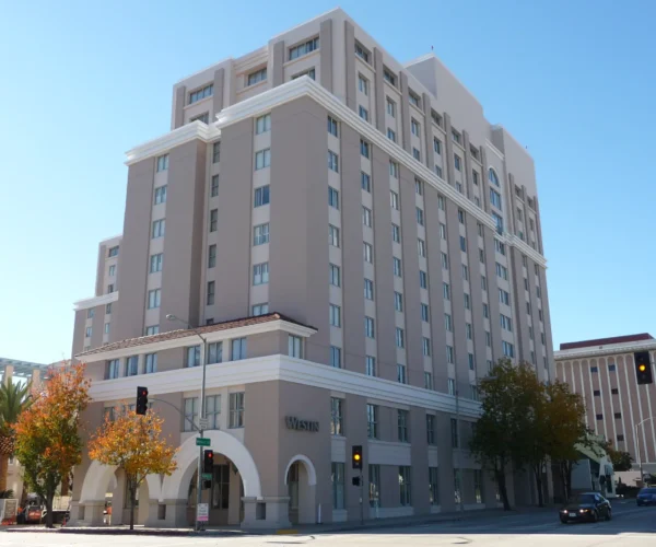 Street-side view of The Westin Pasadena building in downtown Pasadena under clear sky.