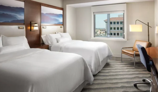 Front view of The Westin Pasadena hotel entrance with palm trees on Los Robles Avenue.