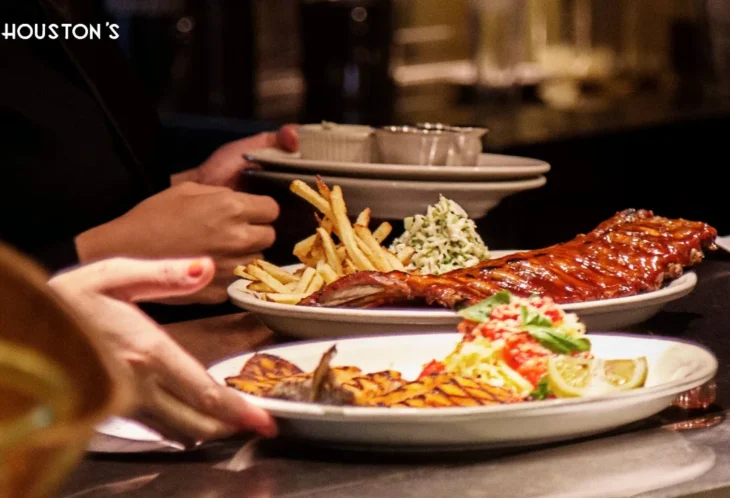houstons-signature-dishes-plating Houston’s signature dishes being plated at the restaurant pass