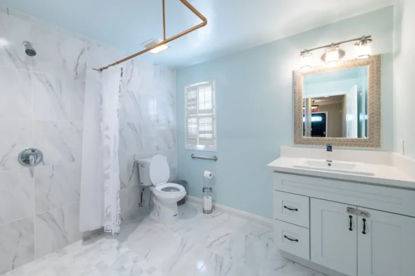 Accessible bathroom at Rose Valley Garfias with walk-in shower, grab bars, and modern vanity designed for assisted living residents