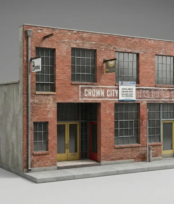 3D miniature model of a two-story red brick building with tall factory windows and storefront doors on a simple grey background