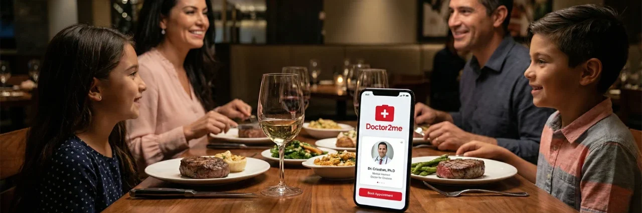 Warm, atmospheric restaurant lighting focusing on a family of four dining at a wooden table with steaks and wine. In the sharp foreground, a smartphone displays the Doctor2me app interface, featuring a prominent red cross, a doctor's portrait, and a bright red "Book Appointment" button. The background shows the smiling family in a soft, cinematic bokeh blur.